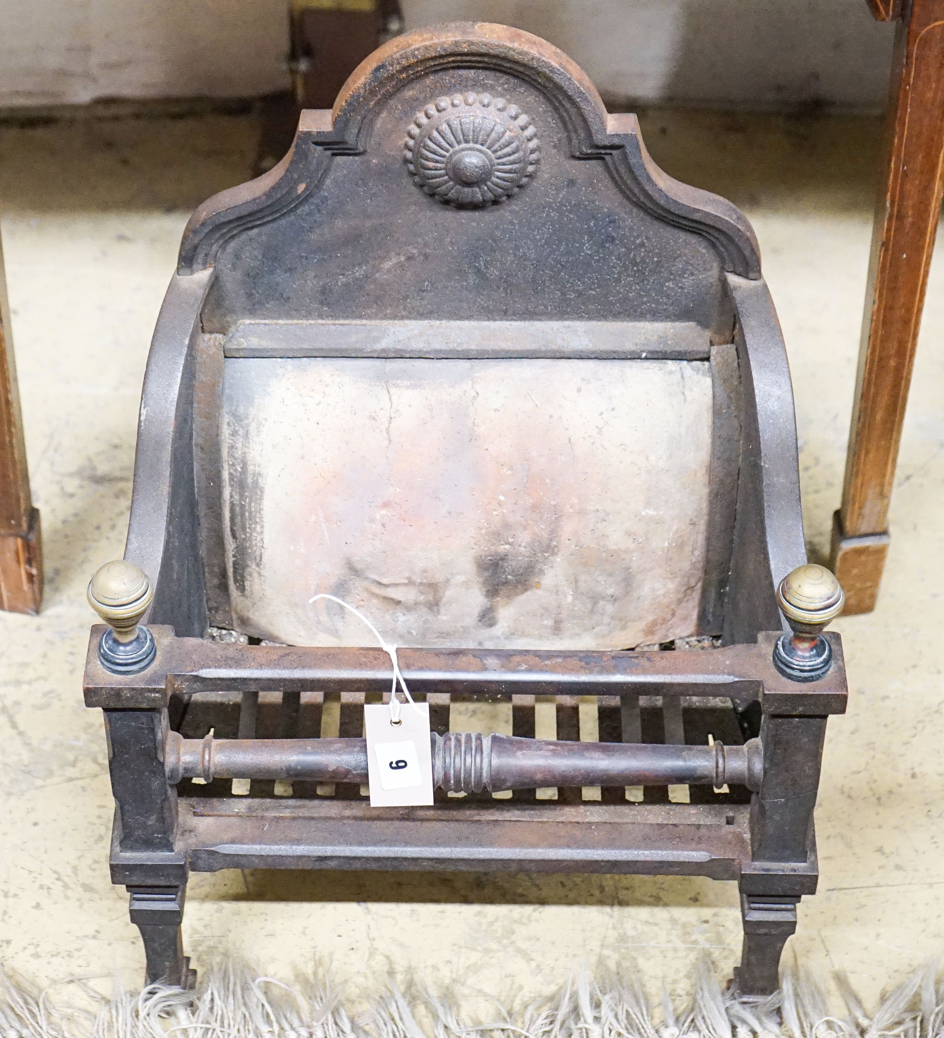 A small iron and brass fire grate, width 41cm, depth 26cm, height 9cm